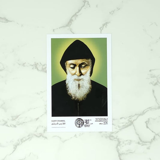 Portrait of Saint Charbel, a religious figure with a beard and black headscarf on a marble background